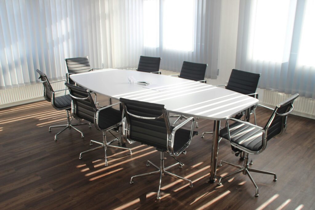pexels-photo-416320-416320-1 Modern office meeting room with designer chairs, table, and large windows.